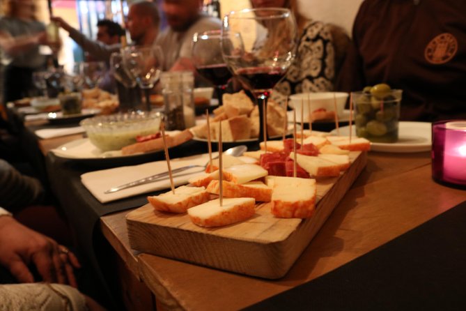 A True Taste of Lisbon: Portuguese Tapas, Wine & Surprise Drink - Starting at Praça Luís de Camões at 7 pm
