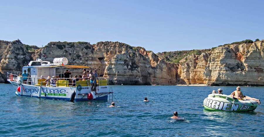 From Lagos: 2.5-Hour Guided Coastal Boat Tour & Grotto Visit - Entering the Grottoes on the Smaller Boat