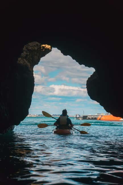From Lagos: Ponta da Piedade Caves Kayak Tour from Catamaran - Sliding from the boat into your kayak