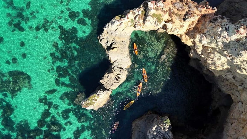 From Lagos: Ponta da Piedade Caves Kayak Tour from Catamaran - The swim stop and catamaran slide