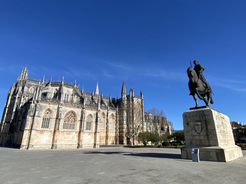 From Lisbon: Fátima, Batalha, Nazaré, and Obidos Tour by Van - Batalha Monastery and its Gothic stonework