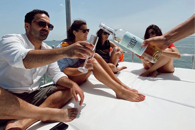 Lisbon: Catamaran Luxury Sunset and Wine Tour - Boarding at Belém and settling into the catamaran