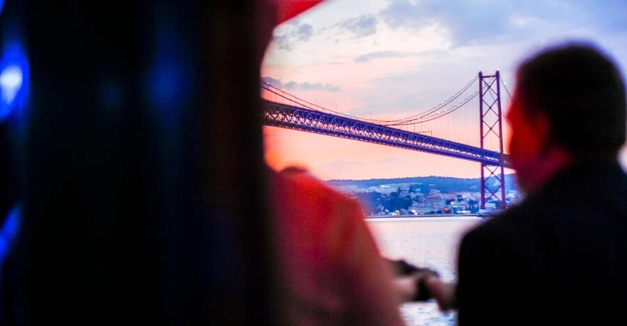 Lisbon: Disco Night Cruise with DJ and Open Bar - Passing under the 25 de Abril Bridge