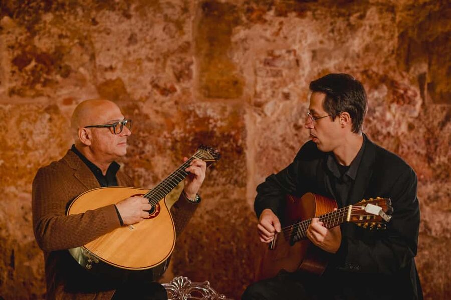 Lisbon: Fado Show with Wine in a Historic Venue - Entering through the blue doors near Sé Cathedral