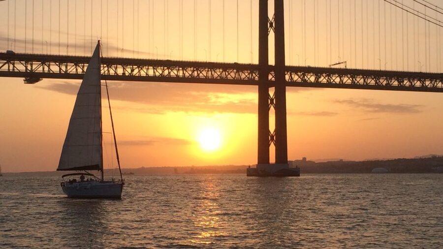 Lisbon: Sunset Cruise with Drinks and Snacks - Passing under the 25 de Abril Bridge