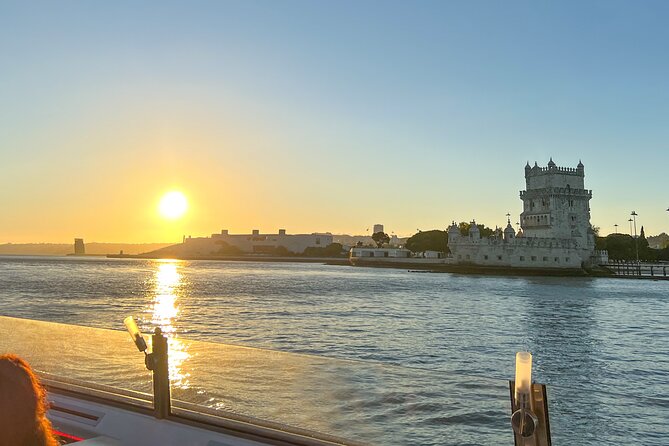 Lisbon Sunset cruise with Welcome Drink and Snack included - Passing beneath the 25 de Abril Bridge