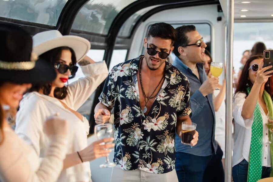 Lisbon: Sunset/Night Boat Party with Open Bar, Snacks & DJ - Crossing beneath Lisbon’s famous bridge