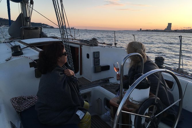 Lisbon Sunset Sailing Tour with White or Rosé Wine and Snacks - Wine, cheese, chouriço, and the onboard atmosphere