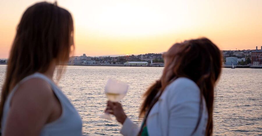 Lisbon: Tagus River Sunset Tour with Snacks and Drink - Passing Alfama’s colorful hillside