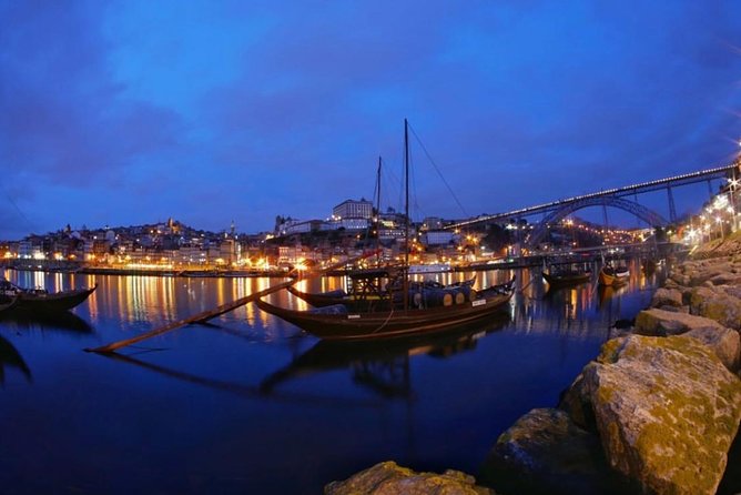 Porto Heritage Night Tour With Fado Show And Dinner Included - Seeing Praça da Ribeira under evening lights