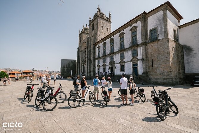 Porto Highlights in 3 Hours E-Bike Tour - Historical, Sightseeing - Clérigos Tower from the lively streets below